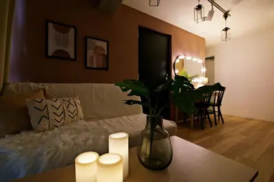 a living room with a couch and a table with candles at Relax Family Inn IKEBUKURO in Tokyo