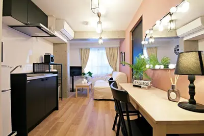 a kitchen and living room with a table and chairs at Relax Family Inn IKEBUKURO in Tokyo
