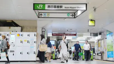 a group of people walking through an airport at LIO HOTEL Tokyo Nippori in Tokyo