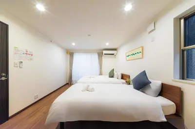 a bedroom with two beds and a window at Starry Stay House Shibuya I in Tokyo