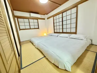 a bedroom with a large white bed with two windows at \u6c5f\u5143Skytree in Tokyo