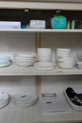 a shelf filled with white plates and bowls at \u6c5f\u5143Skytree in Tokyo