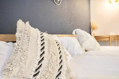 a white bed with white sheets and pillows at Pet\u767e\u4eba\u753a1\u4e01\u76ee202 in Tokyo