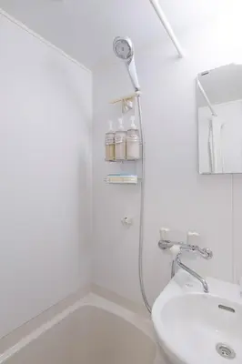 a white bathroom with a shower and a sink at Pet\u767e\u4eba\u753a1\u4e01\u76ee202 in Tokyo