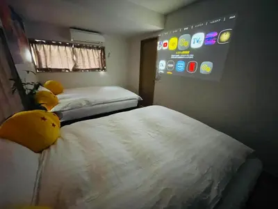 a room with two beds and a sign on the wall at \u9280\u5ddd\u306e\u5bbf in Tokyo
