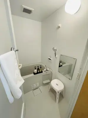 a white bathroom with a toilet and a sink at \u9280\u5ddd\u306e\u5bbf in Tokyo
