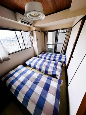 two beds in a train room with windows at Shinjuku Okubo Henna House in Tokyo