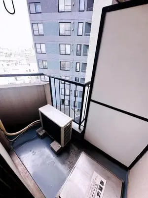 a balcony of a building with a television on it at Shinjuku Okubo Henna House in Tokyo