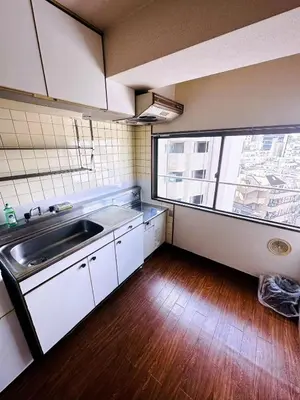 a kitchen with a sink and a large window at Shinjuku Okubo Henna House in Tokyo