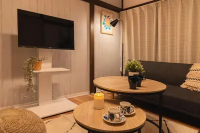 a living room with two tables and a tv at -Shibamata House- 9-minute walk from Shibamata Station in Tokyo
