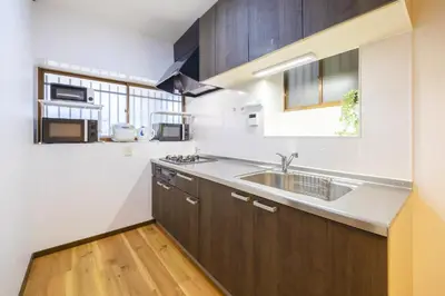 a kitchen with a sink and a microwave at -Shibamata House- 9-minute walk from Shibamata Station in Tokyo