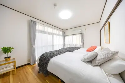 a bedroom with a large white bed and a window at -Shibamata House- 9-minute walk from Shibamata Station in Tokyo