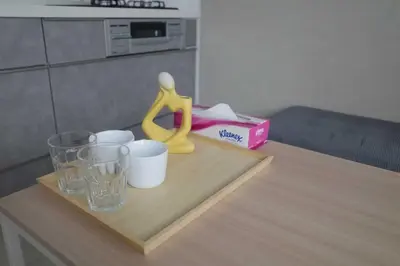 a wooden table with cups and a yellow figurine on it at \u30ea\u30cb\u30e5\u30fc\u30a2\u30eb\u6e08 \u4e0a\u91ce\u79cb\u8449\u539f\u8fd1\u304f\u6700\u59275\u4eba\u5bbf\u6cca\u53ef in Tokyo