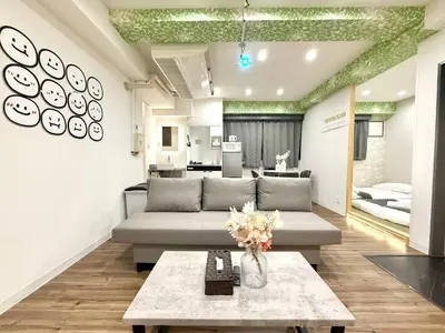 a living room with a couch and a table at \u30af\u30ea\u30b9\u30bf\u30eb\u9ad8\u7530\u99ac\u5834101 in Tokyo