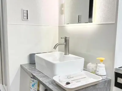 a bathroom with a white sink and a mirror at \u30af\u30ea\u30b9\u30bf\u30eb\u9ad8\u7530\u99ac\u5834101 in Tokyo