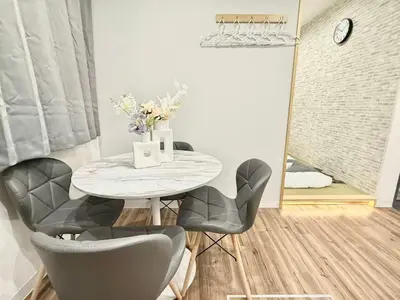 a dining room with a white table and chairs at \u30af\u30ea\u30b9\u30bf\u30eb\u9ad8\u7530\u99ac\u5834101 in Tokyo