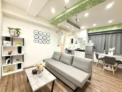 a living room with a couch and a table at \u30af\u30ea\u30b9\u30bf\u30eb\u9ad8\u7530\u99ac\u5834101 in Tokyo