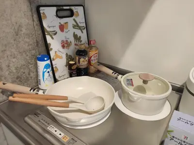 a kitchen counter with a mixing bowl and a measuring cup at 201Room,7-minute walk from Uguisudani Station located on the 2nd floor of an apartment-style building Twin room No elevator in Tokyo