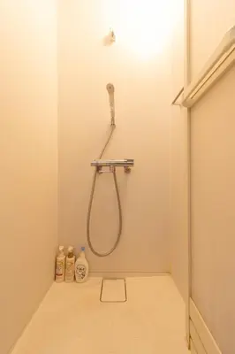 a shower in a bathroom with a shower head at Spacious Private Hotel Floor for up to 16 Guests about 10 minute walk from JR Ryogoku Station HOTEL Musashi Tokyo Ryogoku in Tokyo