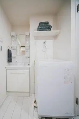 a white bathroom with a sink and a mirror at 2 min by train to Shibuya New 3rd floor 19 square meters in Tokyo