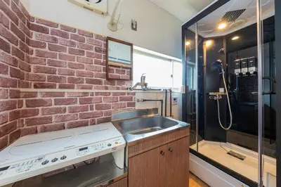 a kitchen with a sink and a brick wall at Joyful JUJO Stay 1minute walk from JR Jujo Station Shibuya 15min Shinjuku 11min Ikebukuro 6min Max 6guests 33square meters Simmons bed in Tokyo
