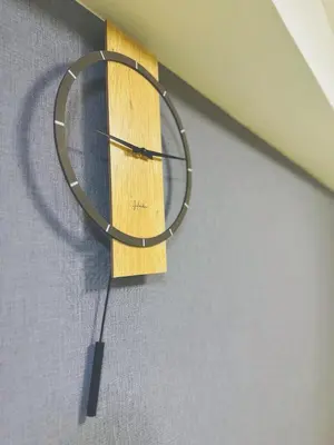a wooden clock hanging on the side of a wall at Shinjuku\u65b0\u5bbf\u516c\u5712 in Tokyo