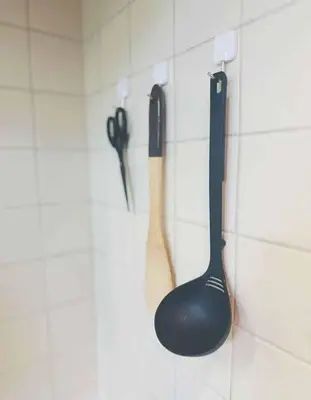 two kitchen utensils are hanging on a wall at Shinjuku\u65b0\u5bbf\u516c\u5712 in Tokyo
