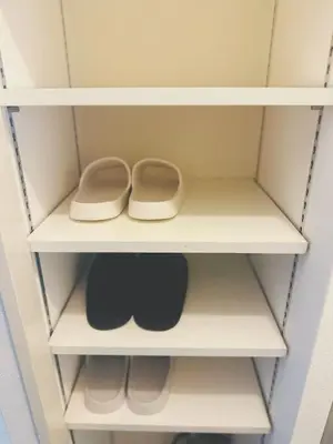 a closet with white shelves with two slippers at Shinjuku\u65b0\u5bbf\u516c\u5712 in Tokyo