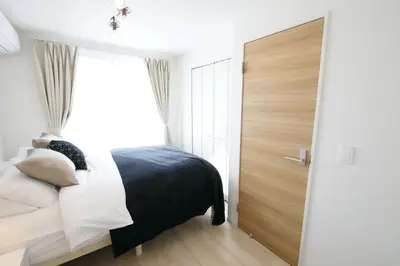 a bedroom with a bed and a large window at Skytree Neighbors close to Asakusa & Tokyo Skytree in Tokyo