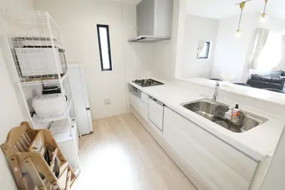 a white kitchen with a sink and a refrigerator at Skytree Neighbors close to Asakusa & Tokyo Skytree in Tokyo