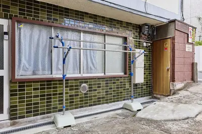a building with a window with a curtain in it at G&R House Premium in Tokyo