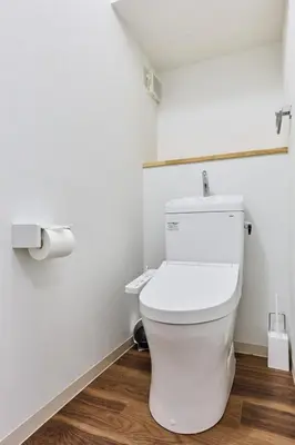 a bathroom with a toilet and a roll of toilet paper at G&R House Premium in Tokyo