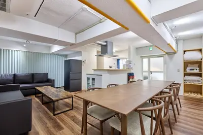 a living room with a table and chairs and a couch at G&R House Premium in Tokyo