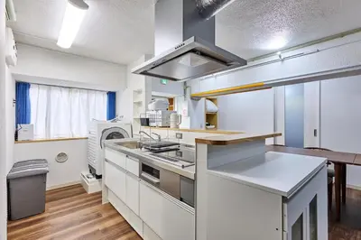 a kitchen with white cabinets and a stove at G&R House Premium in Tokyo