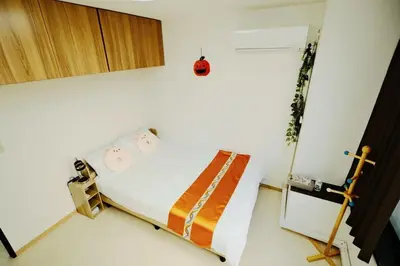 a bedroom with a bed in a white room at Ueno Asakusa 2 in Tokyo