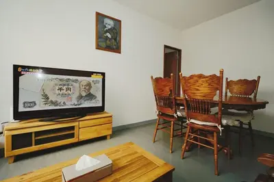 a living room with a tv and a table with chairs at Ueno Asakusa 2 in Tokyo