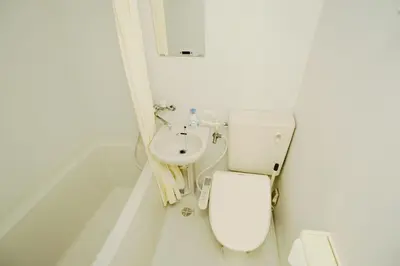 a white bathroom with a toilet and a sink at Ueno Asakusa 2 in Tokyo