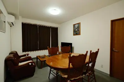 a dining room with a wooden table and chairs at Ueno Asakusa 2 in Tokyo
