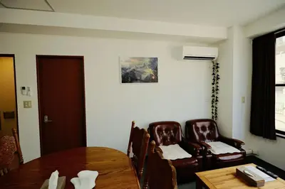 a room with a table and two chairs and a table and a table at Ueno Asakusa 2 in Tokyo