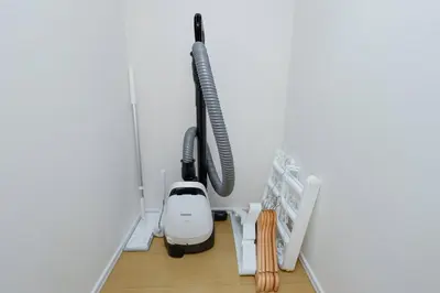 a room with a vacuum in the corner of a wall at Oakville Nezu by Tranova in Tokyo