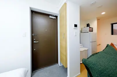 a door leading into a room with a bed at Oakville Nezu by Tranova in Tokyo