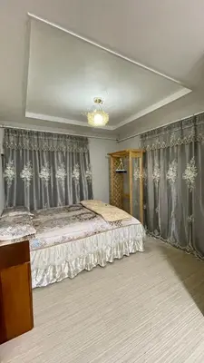 a bedroom with a large bed with gray curtains at \u671b\u6708\u30cf\u30a6\u30b9101 in Tokyo