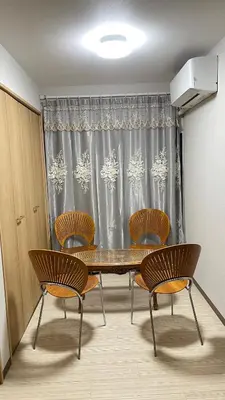 a dining room with a table and chairs and a curtain at \u671b\u6708\u30cf\u30a6\u30b9101 in Tokyo