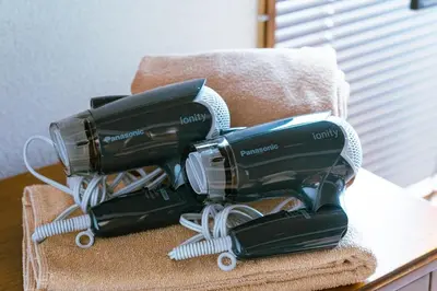 two hair dryers sitting on top of a table at 1ST BASE ICHINOE 3BR House 13 Guests Disney 30min NRT Bus in Tokyo