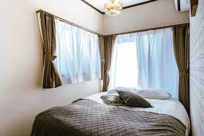 a bedroom with a bed in front of a window at 1ST BASE ICHINOE 3BR House 13 Guests Disney 30min NRT Bus in Tokyo