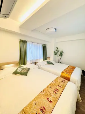 two beds in a room with green curtains at Motosakura 401 Asakusa Ueno Akihabara Area, Bicycle Rental, 6 Minutes to Station, 2 Simmons Beds, Elevator, Direct Access to Airport in Tokyo