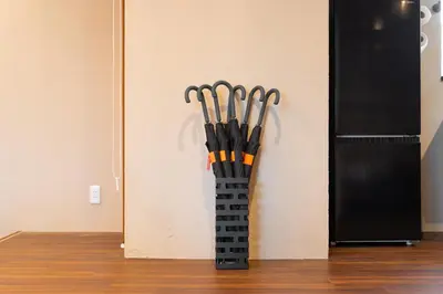 a vase full of baseball bats leaning against a wall at \u6674\u30ec\u5c4b \u65b0\u8fb0\u7f8e\u8358 Hareya Shin-Tatsumiso in Tokyo