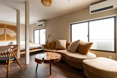 a living room with a couch and a table at \u6674\u30ec\u5c4b \u65b0\u8fb0\u7f8e\u8358 Hareya Shin-Tatsumiso in Tokyo