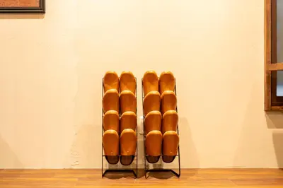 a group of baseball bats sitting on a rack at \u6674\u30ec\u5c4b \u7b51\u6ce2\u8358 Hareya Tsukubaso in Tokyo