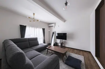 a living room with a couch and a table at \u5317\u5c0f\u5ca9\u6238\u5efa in Tokyo